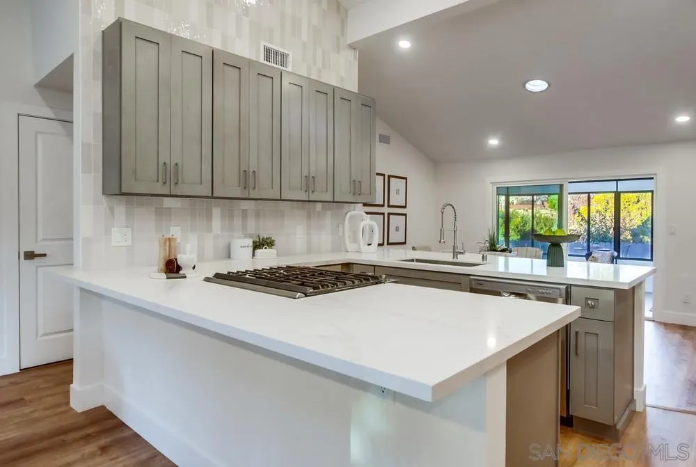 4793 54th Street San Diego, CA 92115 - Photo 28 of 74 a kitchen with a stove a sink and a refrigerator