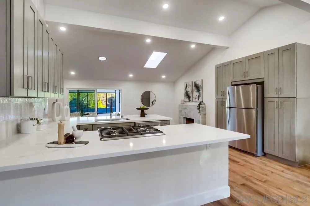 4793 54th Street San Diego, CA 92115 - Photo 29 of 74 a kitchen with stainless steel appliances a sink a stove a refrigerator and cabinets