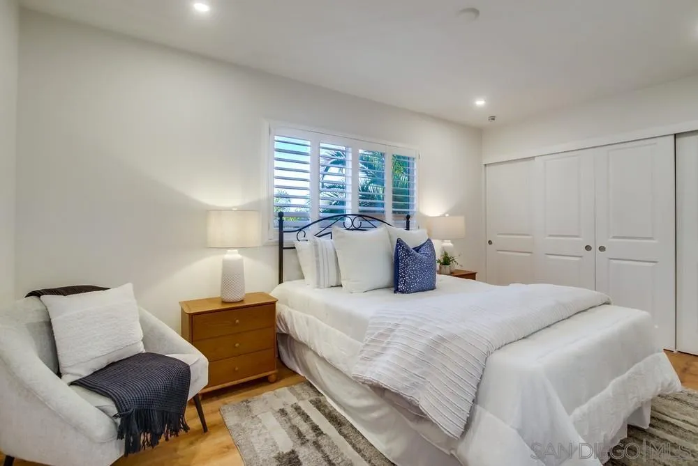 4793 54th Street San Diego, CA 92115 - Photo 34 of 74 a bedroom with a bed and wooden floor