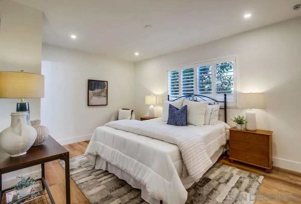 4793 54th Street San Diego, CA 92115 - Photo 37 of 74 a bedroom with a bed and a lamp on dresser