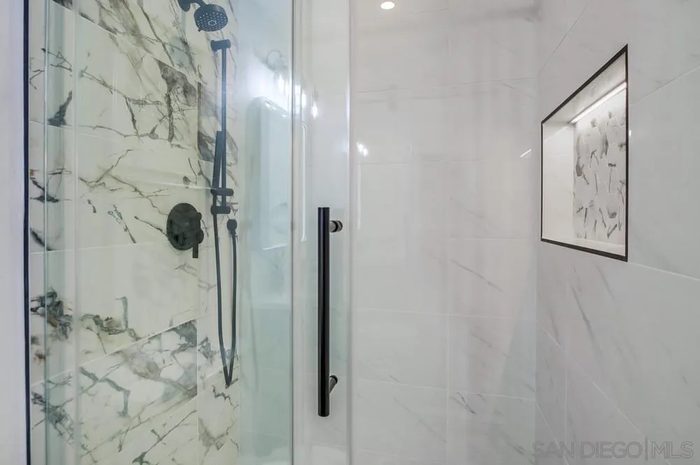 4793 54th Street San Diego, CA 92115 - Photo 39 of 74 a bathroom with a glass shower door