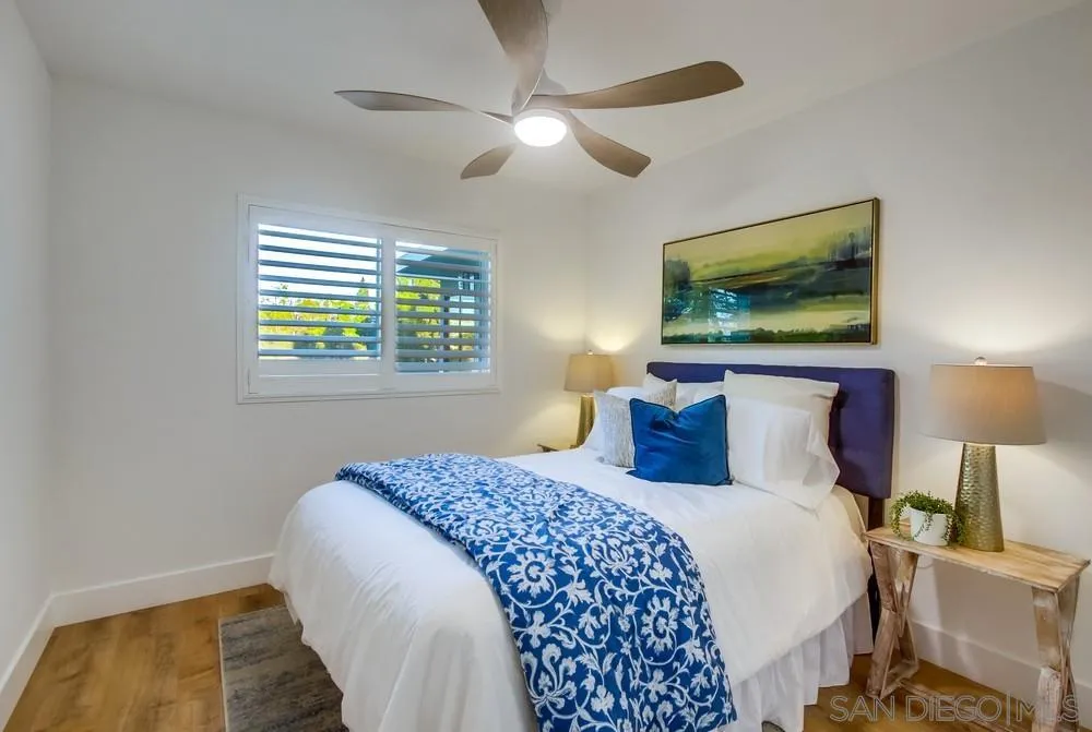 4793 54th Street San Diego, CA 92115 - Photo 40 of 74 a bedroom with a bed a painting on the wall and a window