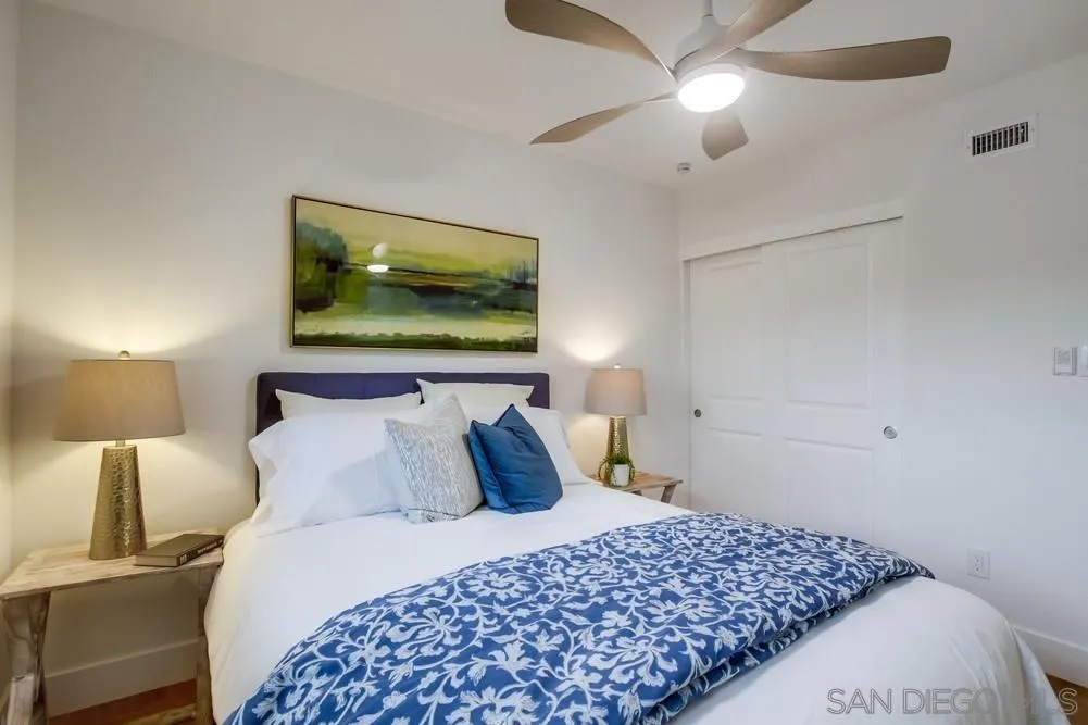 4793 54th Street San Diego, CA 92115 - Photo 41 of 74 a bedroom with a bed and a chandelier