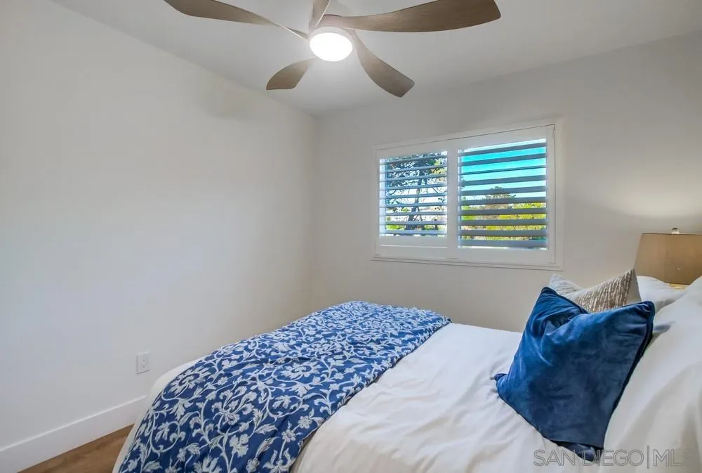 4793 54th Street San Diego, CA 92115 - Photo 42 of 74 a bedroom with a bed and a chandelier
