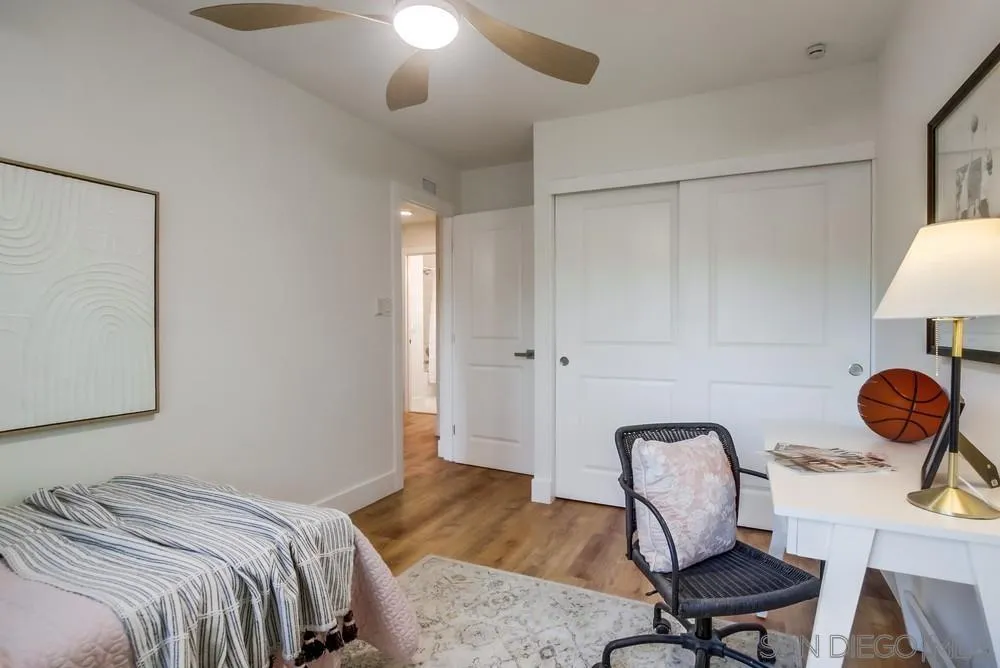 4793 54th Street San Diego, CA 92115 - Photo 44 of 74 a bedroom with a bed and a chandelier