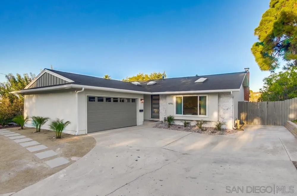 4793 54th Street San Diego, CA 92115 - Photo 50 of 74 a front view of a house with a yard and a garage