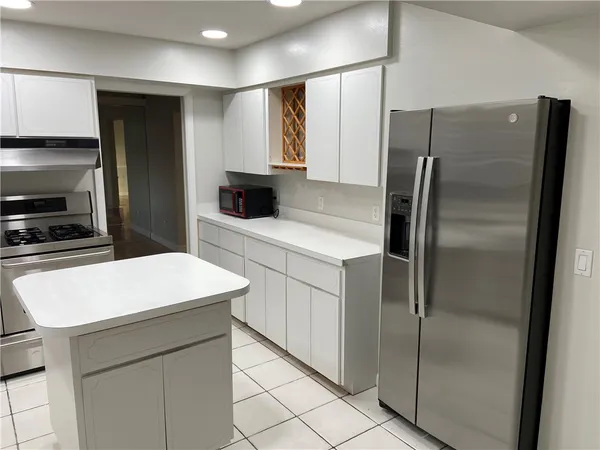 a kitchen with a refrigerator and a sink