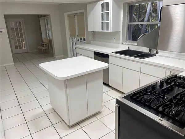 a kitchen with a stove a sink and a refrigerator
