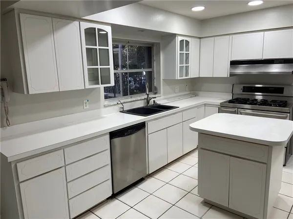 a kitchen with a sink and cabinets