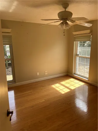 a view of empty room with wooden floor