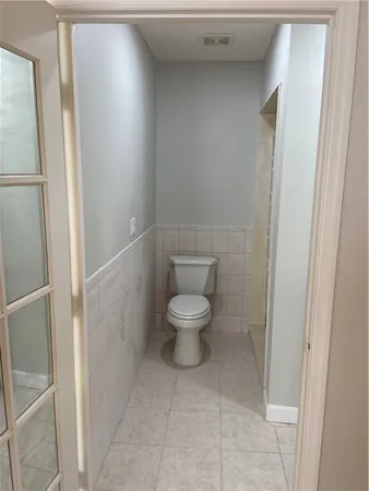 a white toilet sitting next to a shower