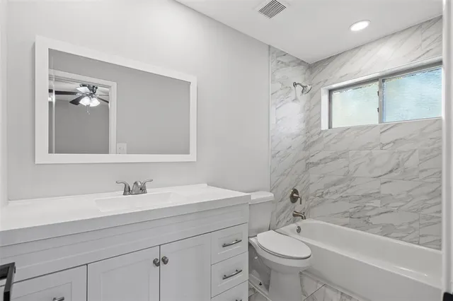 a bathroom with a double vanity sink toilet and shower