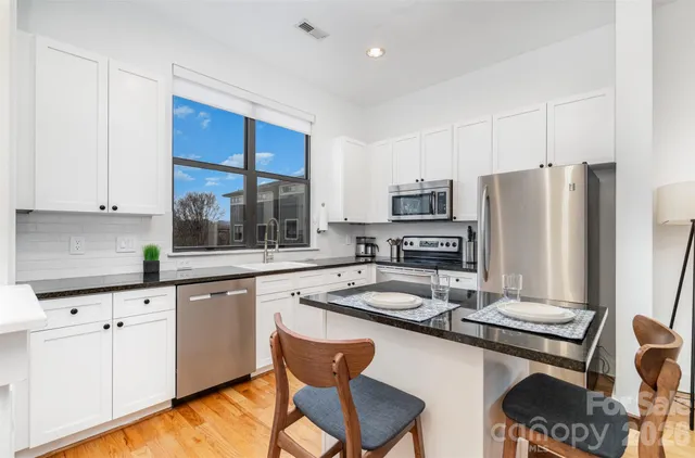 a kitchen with a sink stove and refrigerator