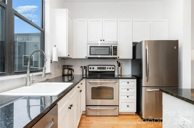 a spacious bedroom with a bed couch and a window