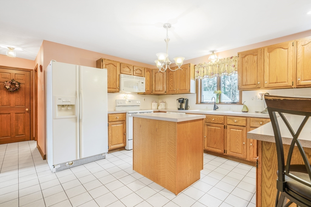 7 Bow Drive Acushnet, MA 02743 - Photo 17 of 42 a kitchen with stainless steel appliances granite countertop a refrigerator a sink and a stove