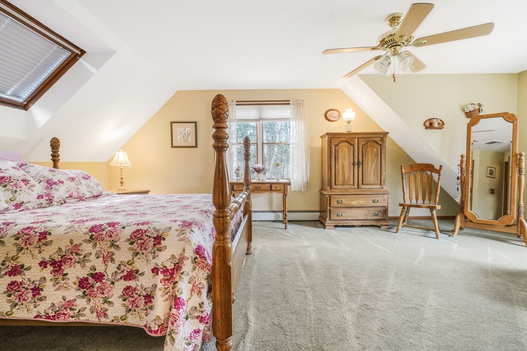 7 Bow Drive Acushnet, MA 02743 - Photo 35 of 42 a bedroom with a bed a mirror and a chandelier