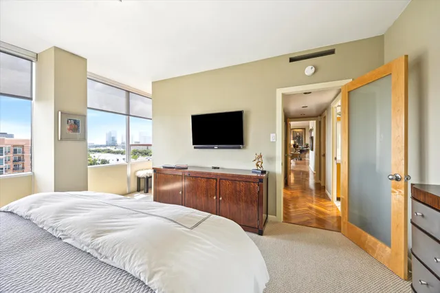 a bedroom with a bed and a flat screen tv