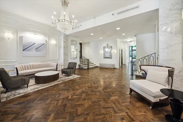 a living room with furniture and a chandelier
