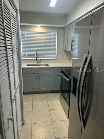 283 Gardner Lane, Unit D Kissimmee, FL 34743 - Photo 6 of 12 a kitchen with a sink a refrigerator and window