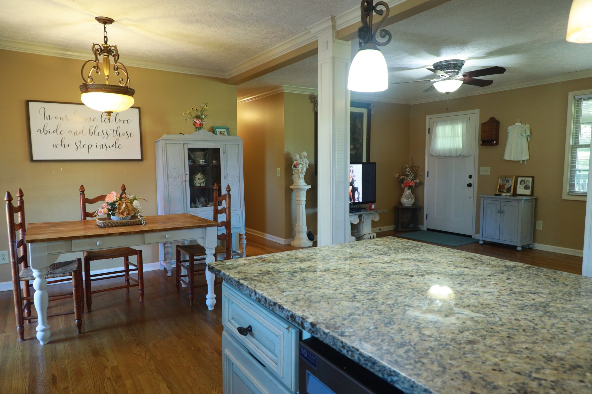 12354 Owens Chapel Road Springfield, TN 37172 - Photo 14 of 51 a kitchen with kitchen island a chandelier and living room