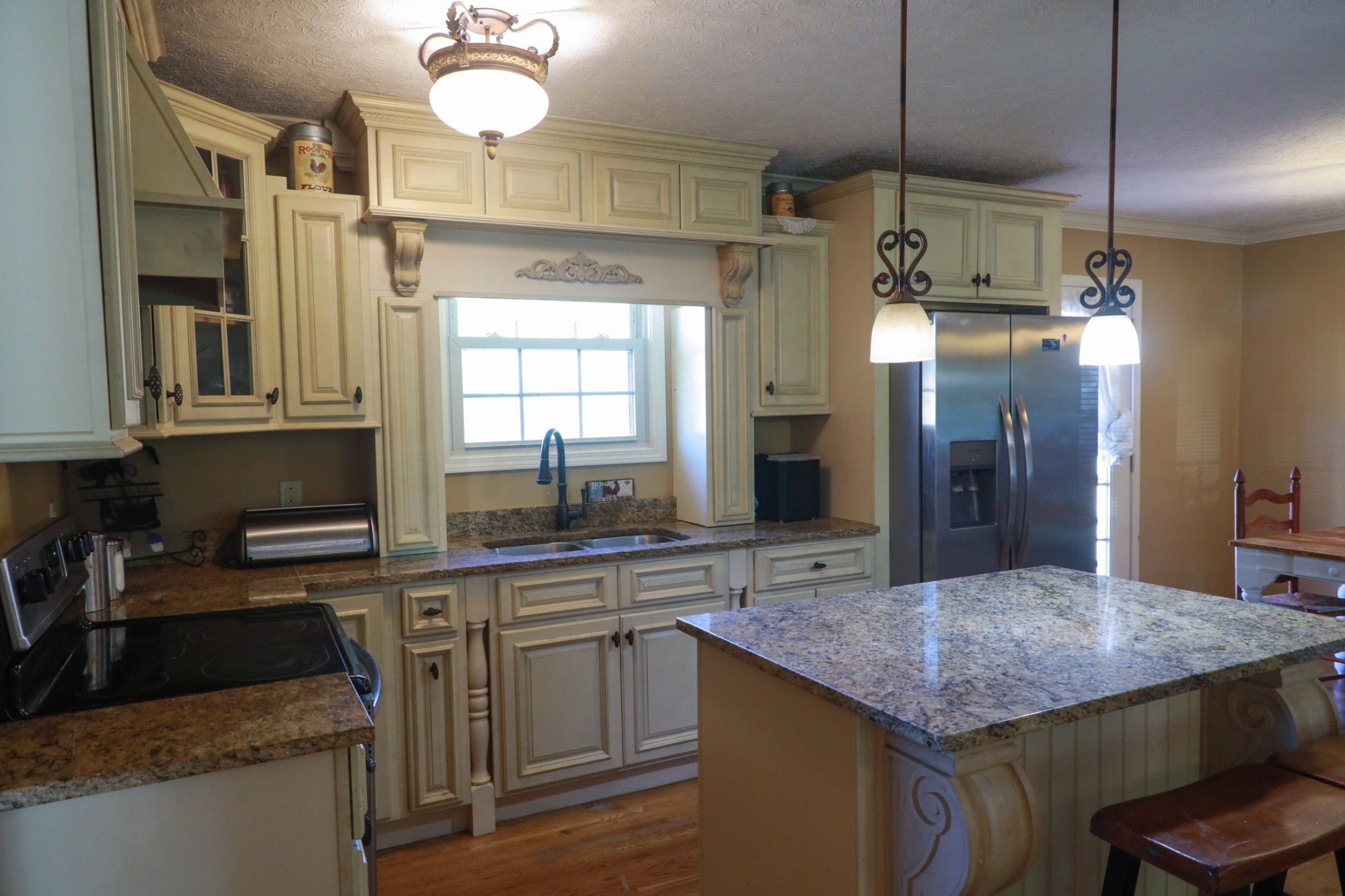 12354 Owens Chapel Road Springfield, TN 37172 - Photo 15 of 51 a kitchen with kitchen island granite countertop a sink a counter space appliances and cabinets