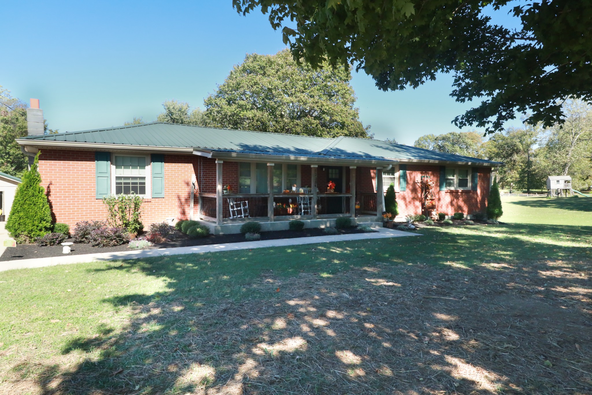 12354 Owens Chapel Road Springfield, TN 37172 - Photo 4 of 51 a view of patio with a table and chairs under an umbrella