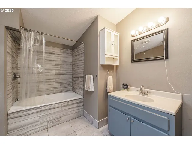 a bathroom with a sink a mirror and a shower