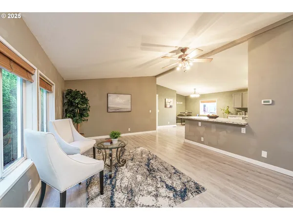 a living room with kitchen island furniture and a chandelier
