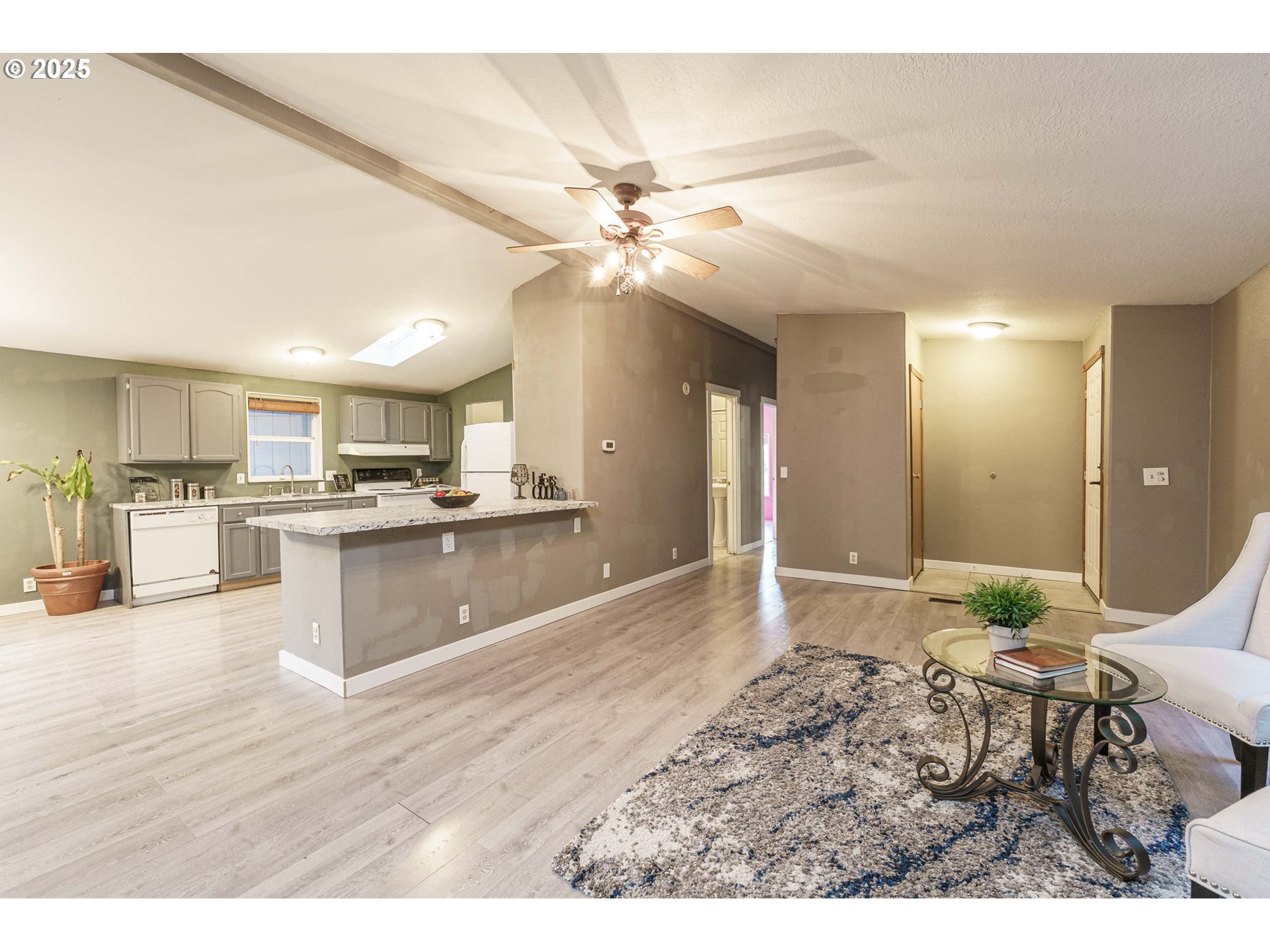 3777 Addy Street, Unit 17 Washougal, WA 98671 - Photo 7 of 25 a large white kitchen with kitchen island a sink stainless steel appliances and cabinets
