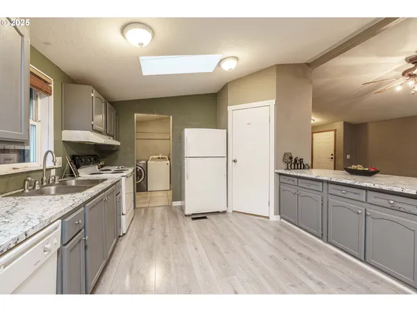 a kitchen with a sink a refrigerator and a stove