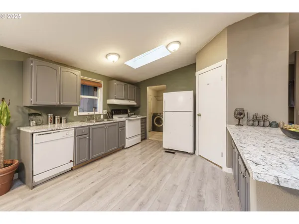 a kitchen with a refrigerator a stove top oven and a center island
