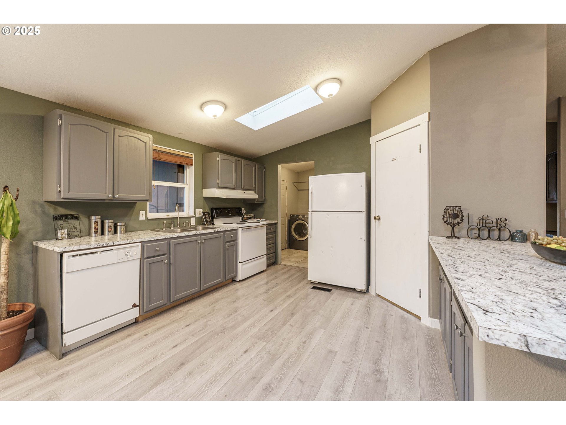 3777 Addy Street, Unit 17 Washougal, WA 98671 - Photo 10 of 25 a kitchen with a refrigerator a stove top oven and a center island