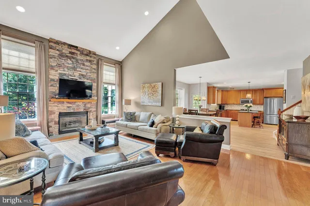 a living room with furniture a rug and a table