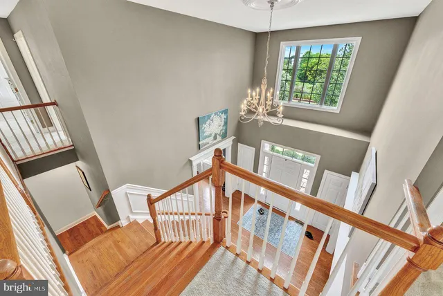 a bed sitting in a spacious bedroom next to a window