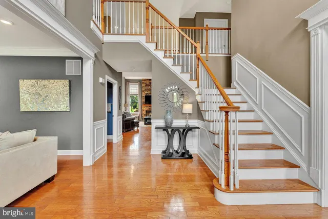 a view of entryway and hall with wooden floor