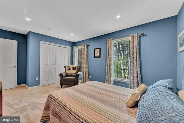 a bedroom with a bed and a couch