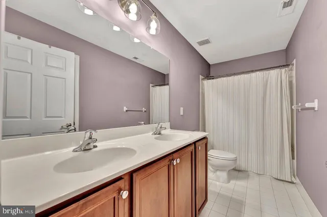 a living room with fireplace furniture and a flat screen tv