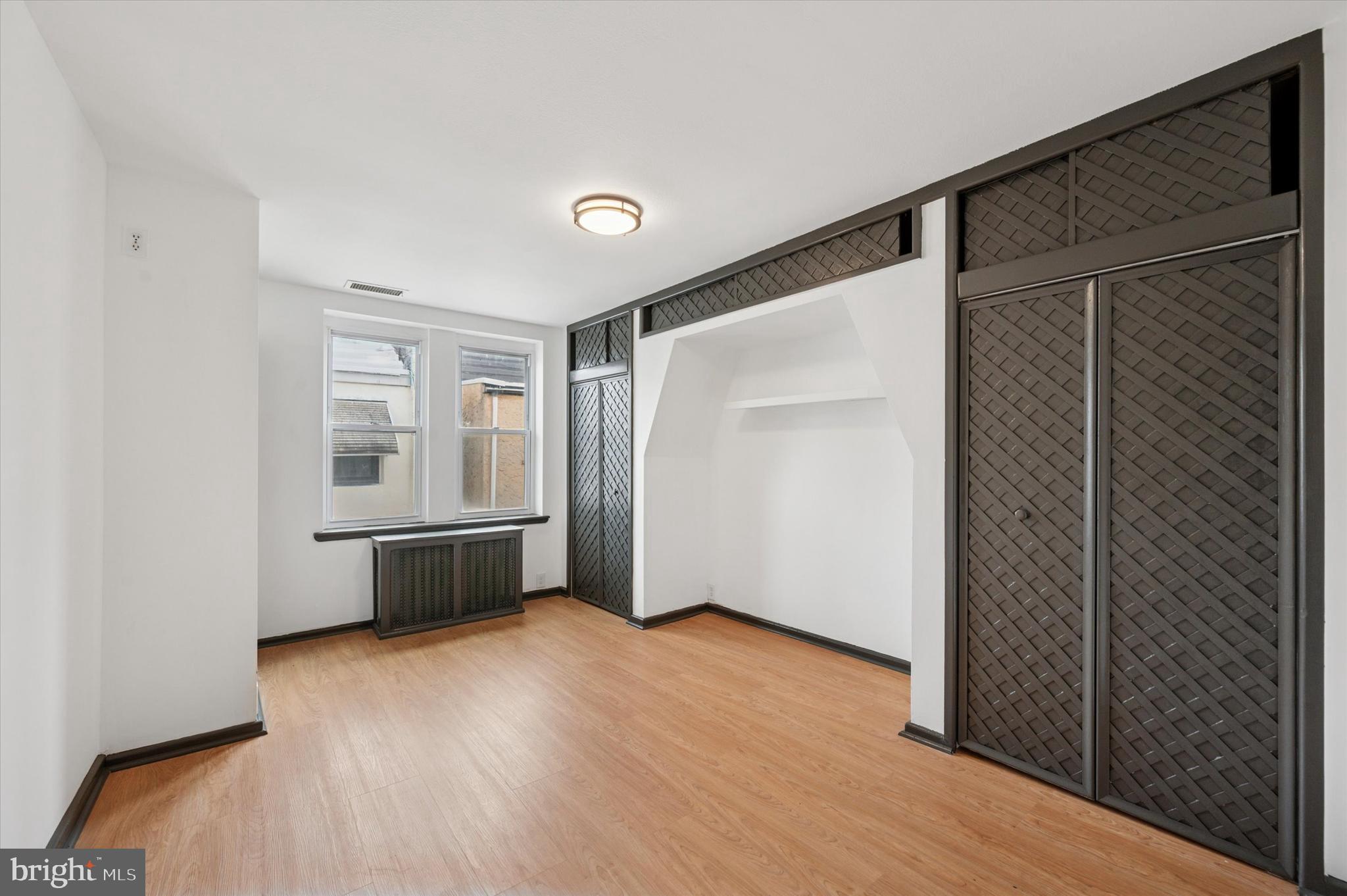913 Tasker Street Philadelphia, PA 19148 - Photo 11 of 22 a view of an empty room with wooden floor and a window
