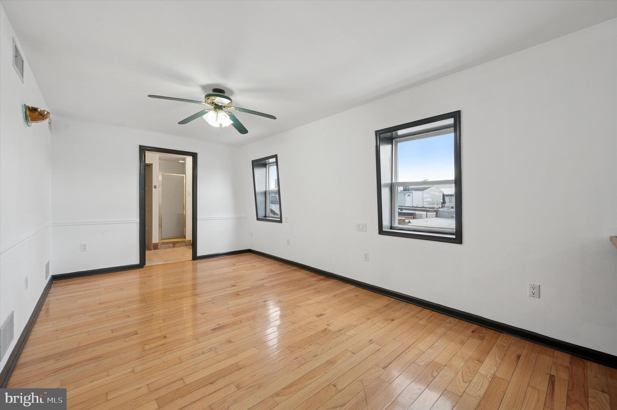 913 Tasker Street Philadelphia, PA 19148 - Photo 15 of 22 a view of empty room with wooden floor and fan