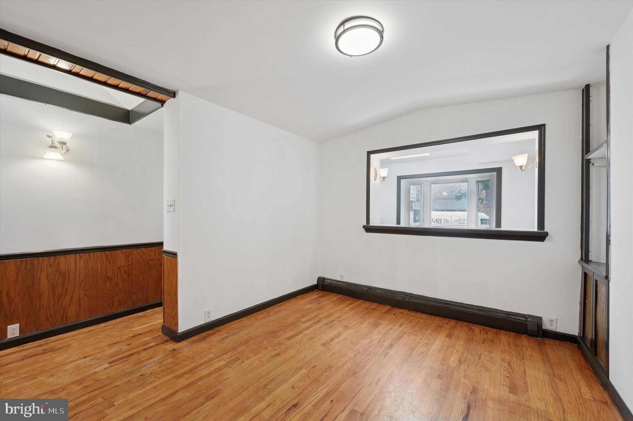 913 Tasker Street Philadelphia, PA 19148 - Photo 22 of 22 a view of a room with wooden floor and a window
