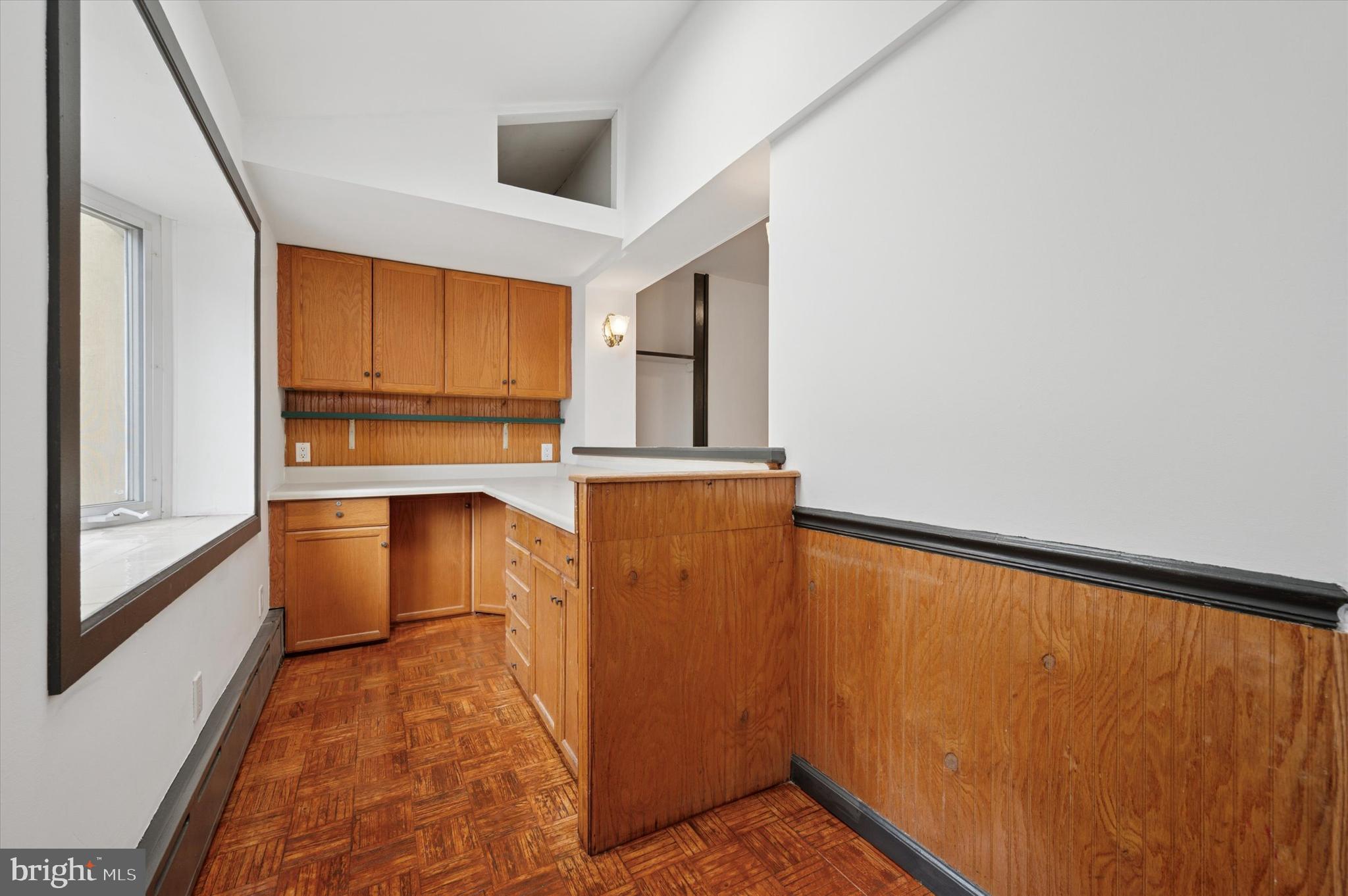 913 Tasker Street Philadelphia, PA 19148 - Photo 3 of 22 a view of a kitchen with wooden floor and a window