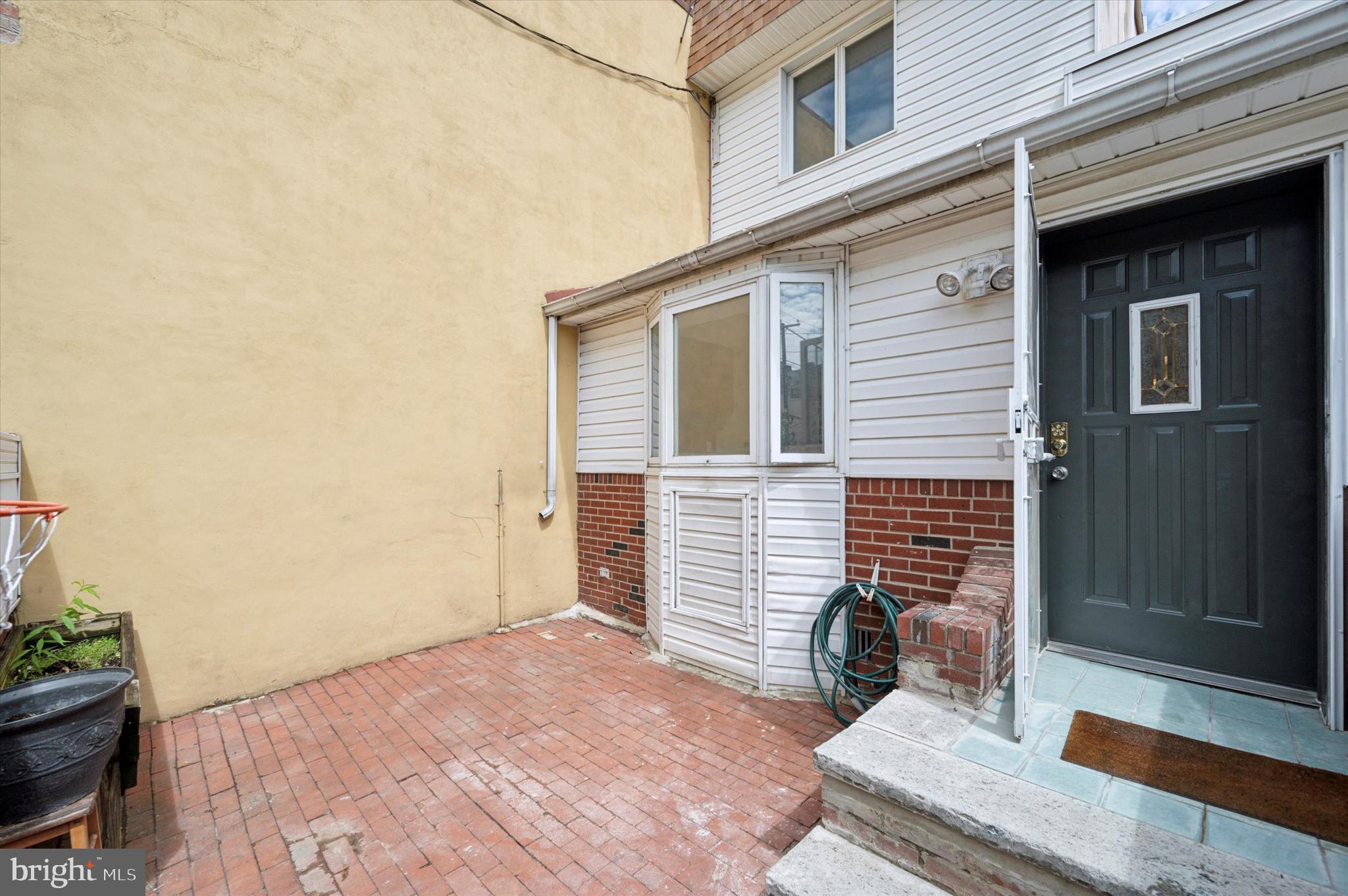 913 Tasker Street Philadelphia, PA 19148 - Photo 8 of 22 a view of a house with a door and wooden bench