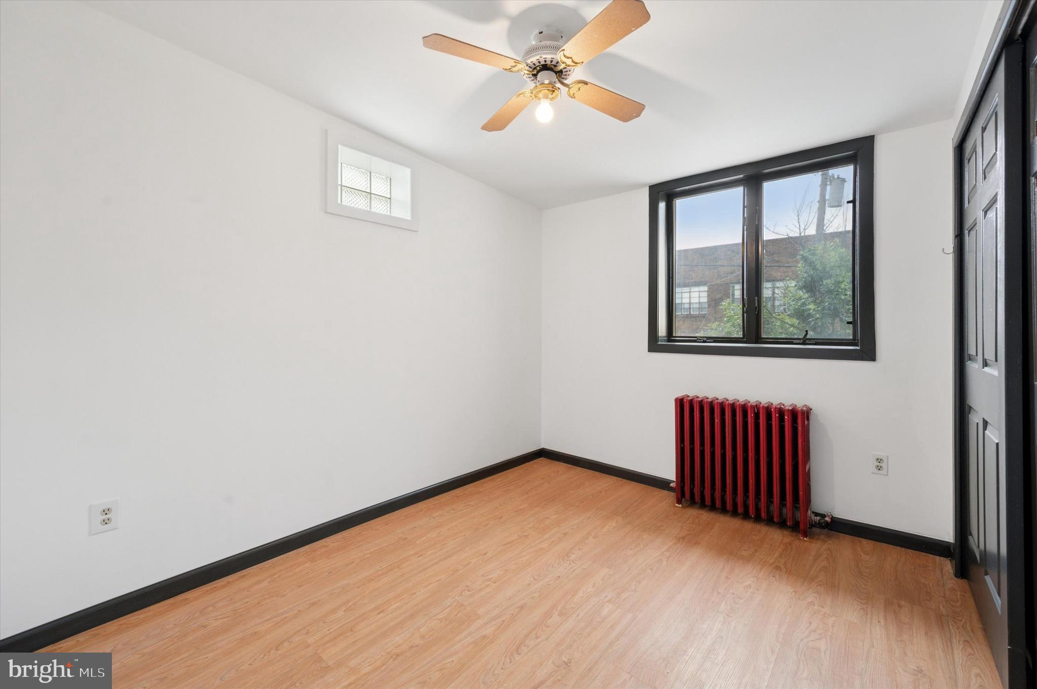 913 Tasker Street Philadelphia, PA 19148 - Photo 10 of 22 an empty room with windows and cabinet