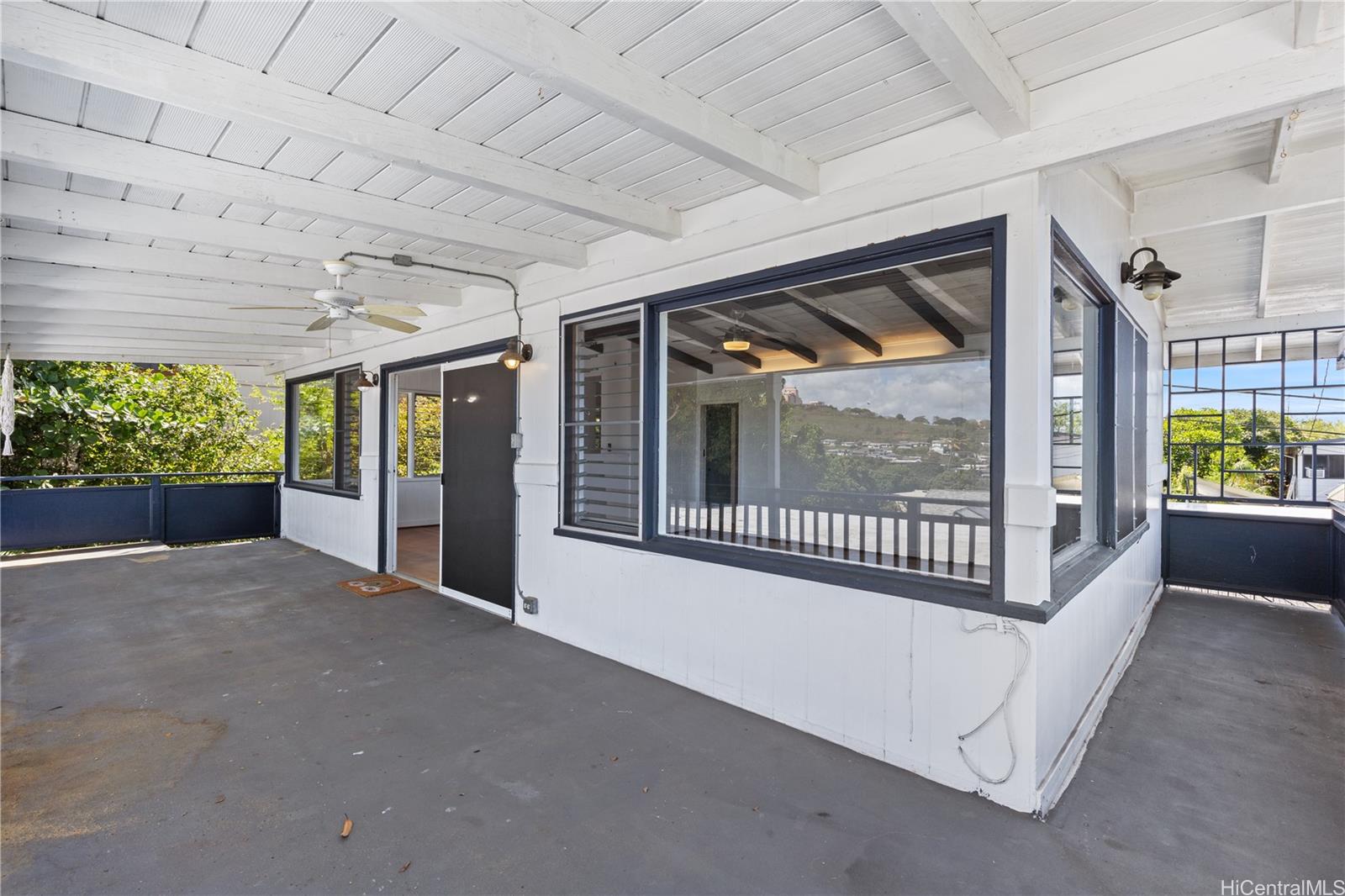 1554 Ala Amoamo Street Honolulu, HI 96819 - Photo 11 of 19 a view of a porch with furniture and front door
