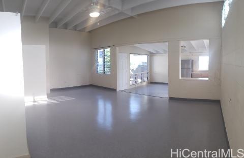 1554 Ala Amoamo Street Honolulu, HI 96819 - Photo 15 of 19 an empty room with wooden floor and windows