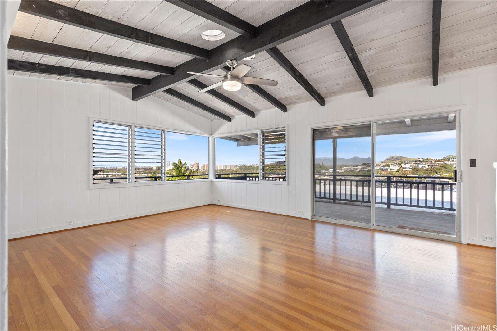 1554 Ala Amoamo Street Honolulu, HI 96819 - Photo 2 of 19 a view of an empty room with wooden floor and a window