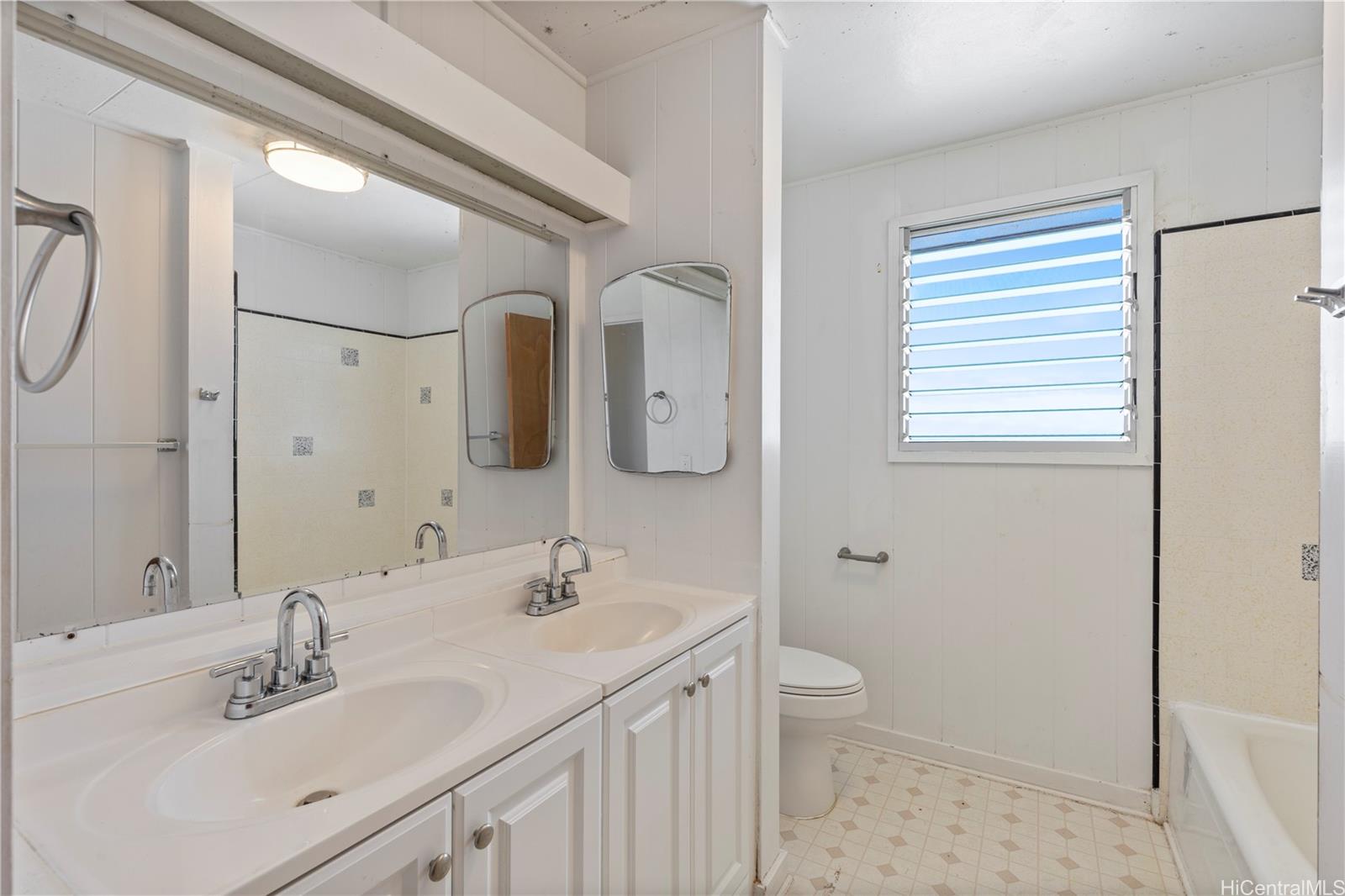 1554 Ala Amoamo Street Honolulu, HI 96819 - Photo 6 of 19 a bathroom with a double vanity sink mirror and toilet
