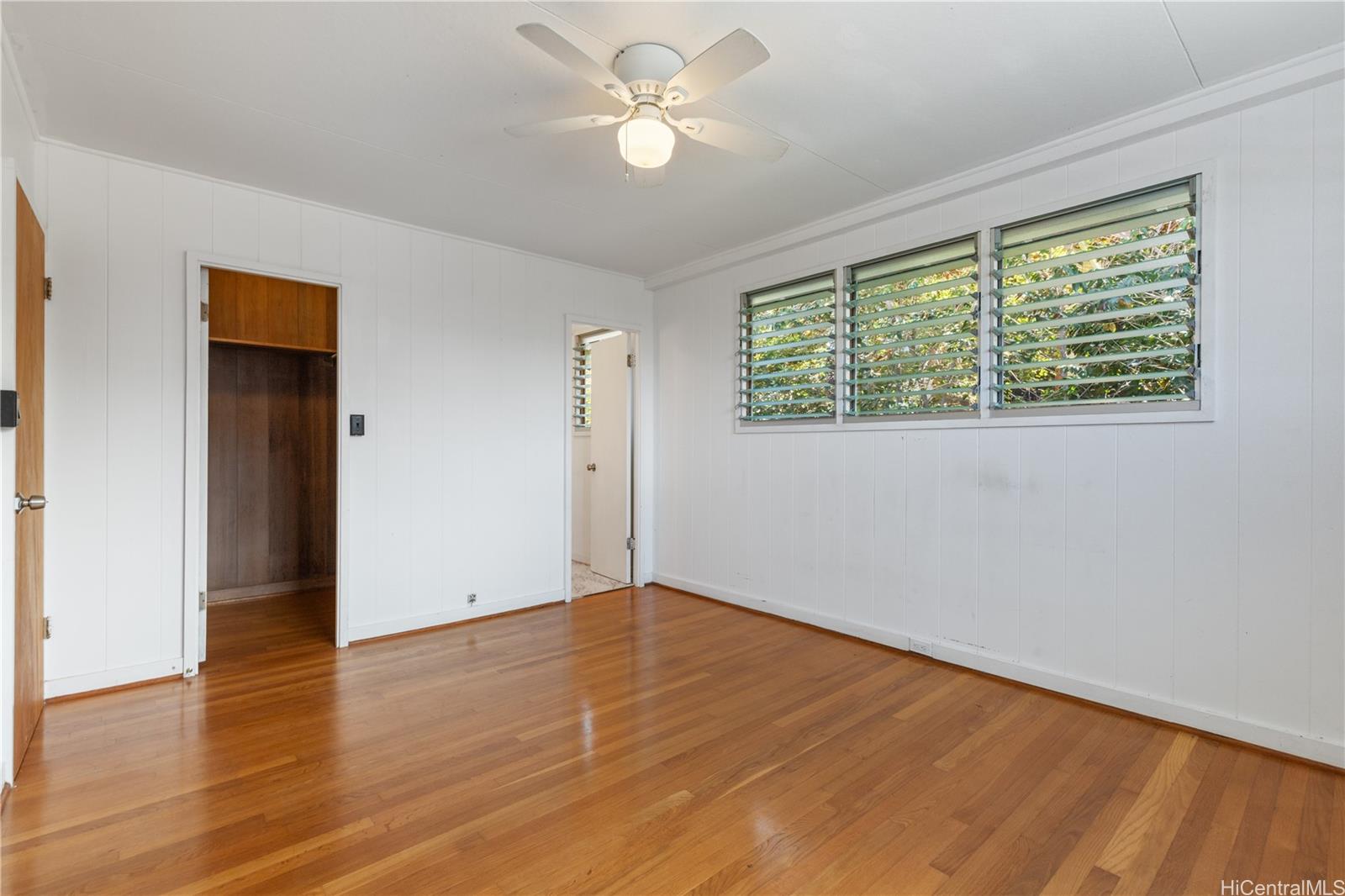 1554 Ala Amoamo Street Honolulu, HI 96819 - Photo 7 of 19 wooden floor in an empty room with a window