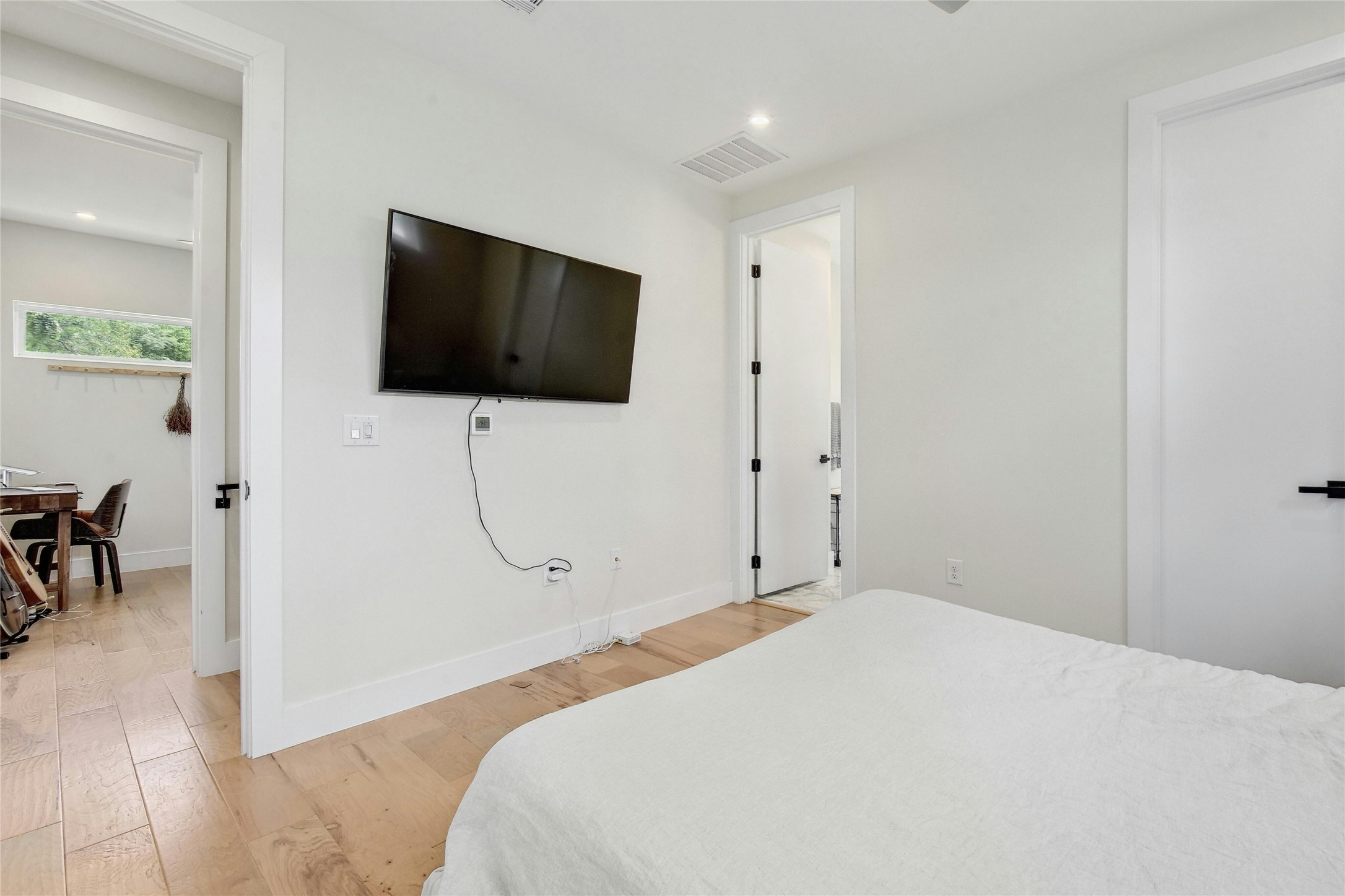 4606 Ledesma Road, Unit 2 Austin, TX 78721 - Photo 18 of 33 Well-lit sleeping quarters with rich hardwood flooring and a clean, minimalist design await.