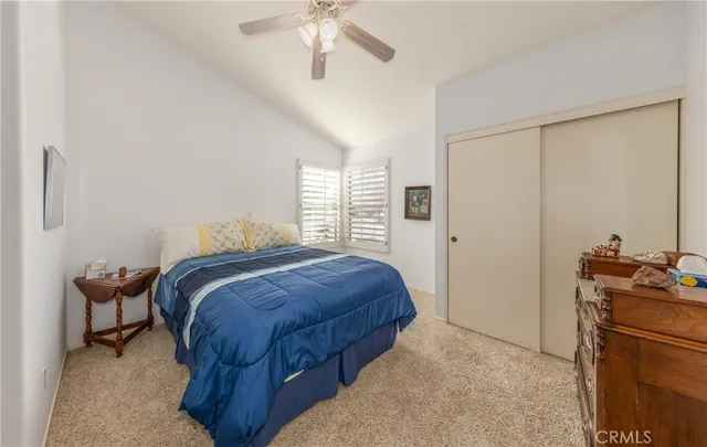 a bathroom with a granite countertop sink mirror and a toilet